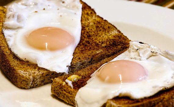 Photograph of fried eggs on brown toast